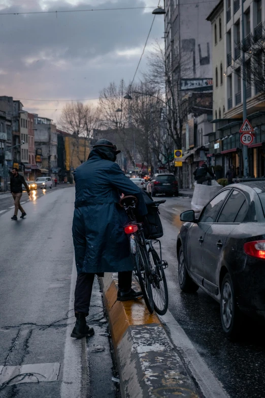 a person riding a bicycle with an umbrella on the street