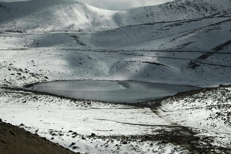 some snowy mountains and a body of water