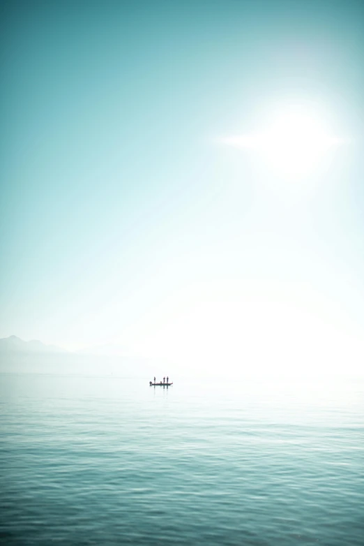 some small boats in the middle of a large body of water