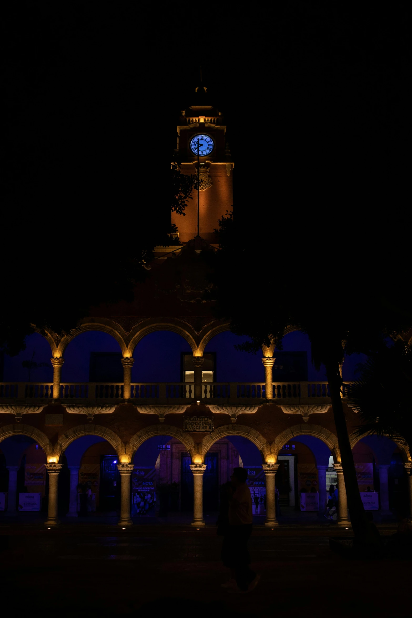 a building with illuminated arches and a clock tower