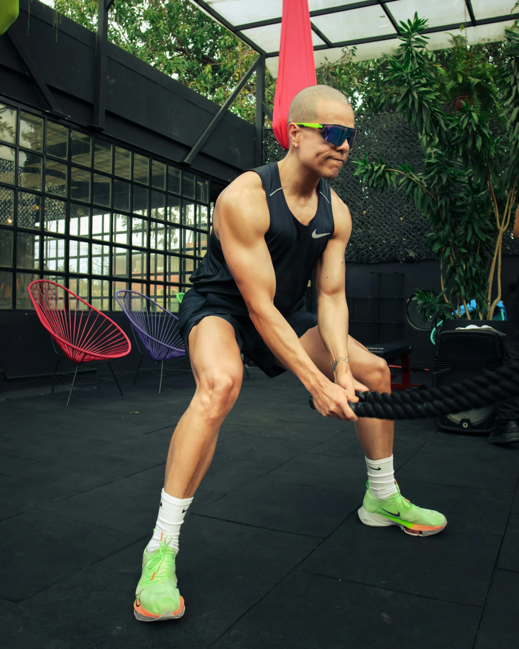 a man holding his tennis racquet over his knee as he stretches out