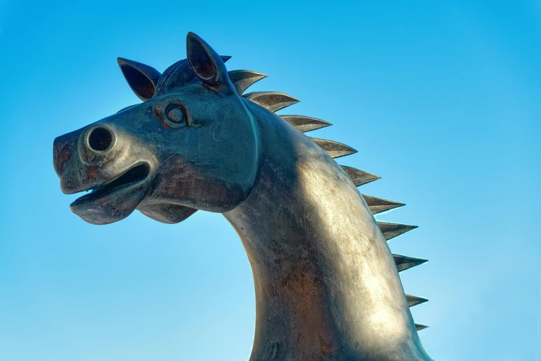 a horse head statue with spikes on its head