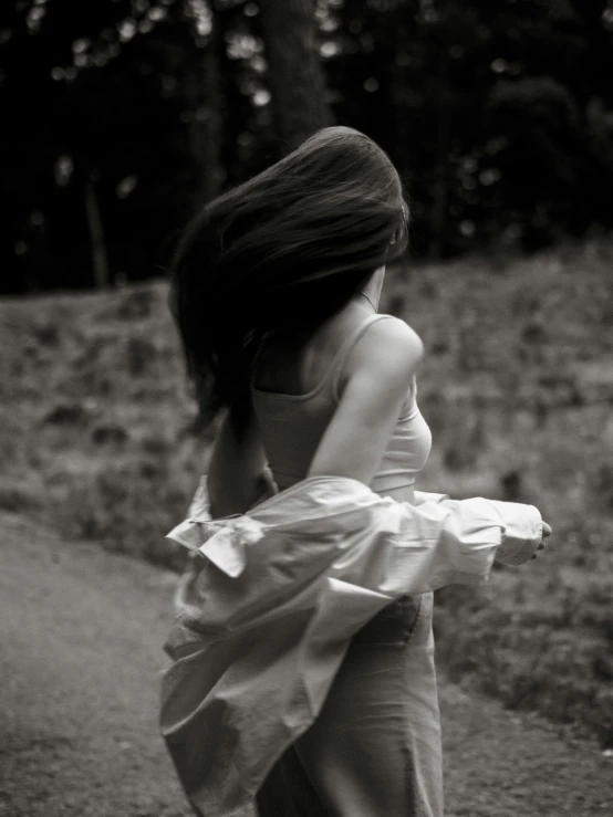 black and white pograph of woman with dress back view