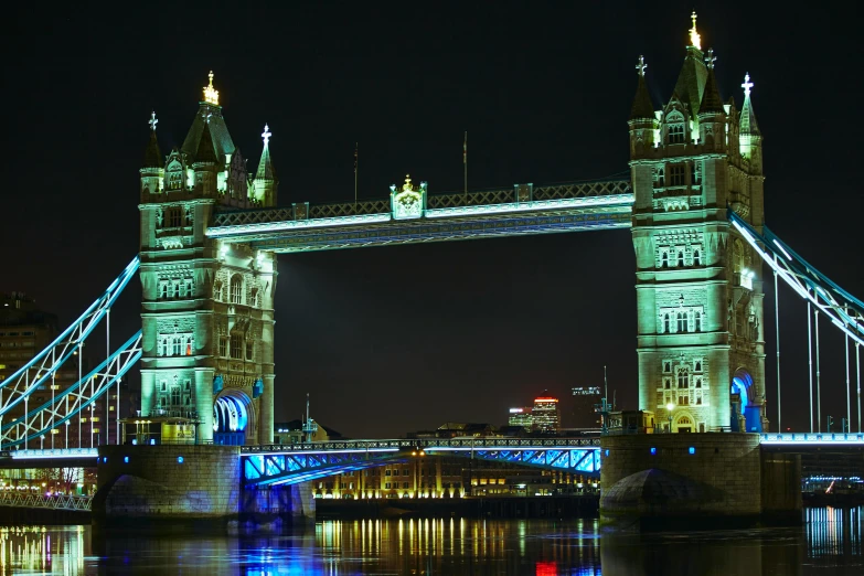 the bridge is illuminated with multi - colored lights