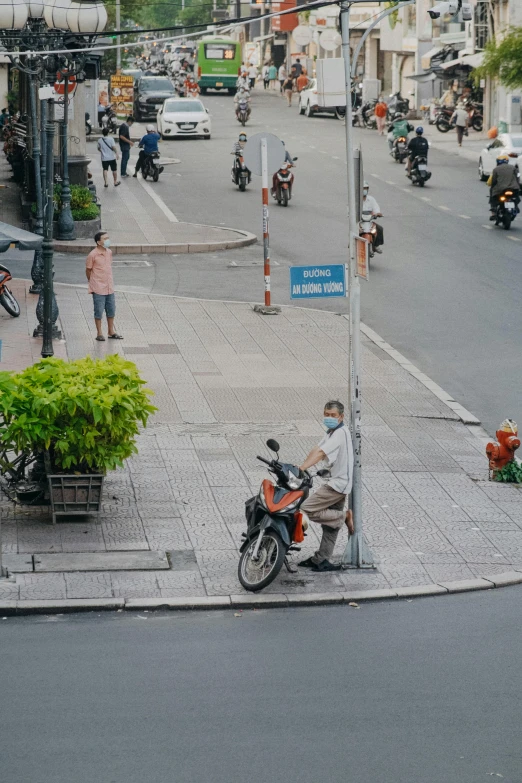 a man is on a motorcycle in the middle of a street