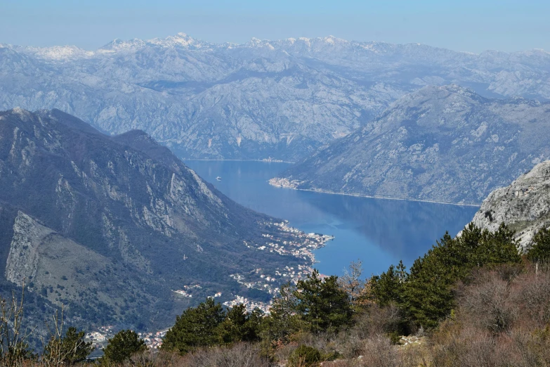 an expansive landscape with mountains and lake