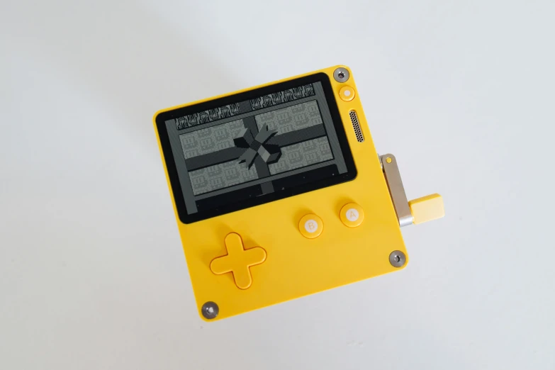 yellow game boy handheld with black and white game