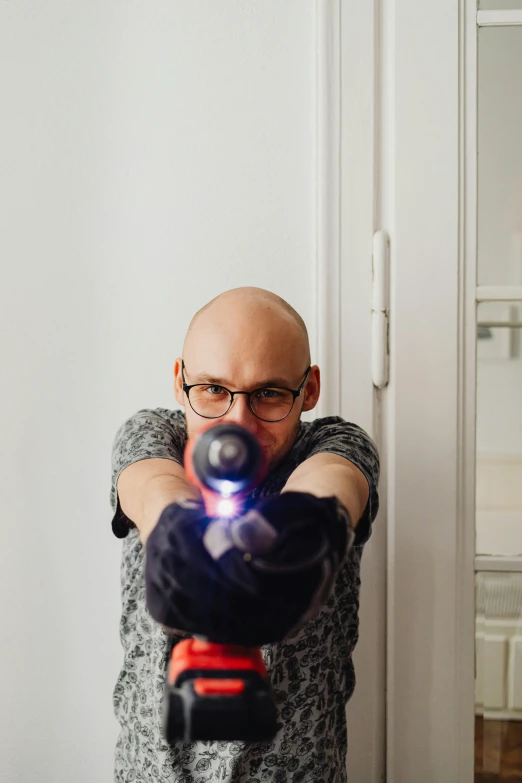 a man pointing a toy gun at a camera