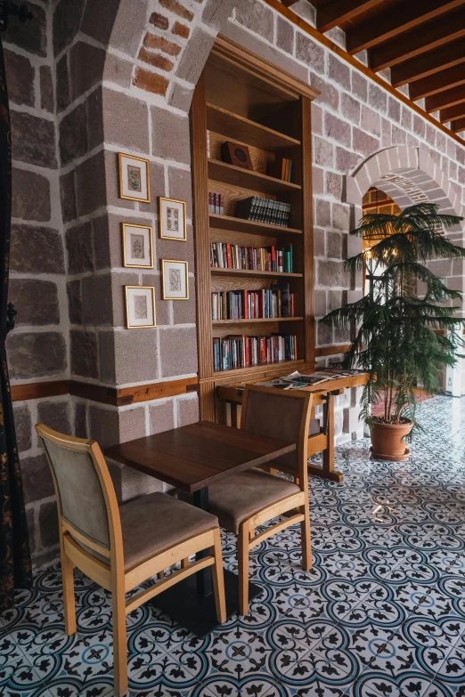 an ornate living room area features wooden chairs and a stone walled wall