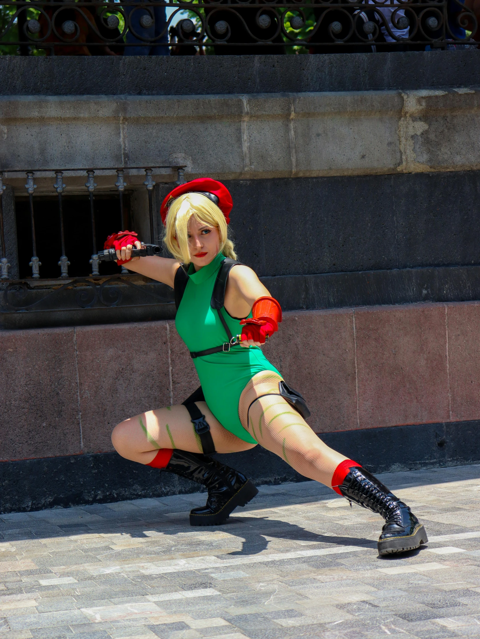 a woman in green dress on city sidewalk