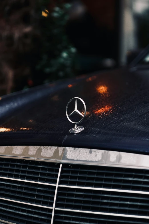 a mercedes badge is on the front of a vehicle