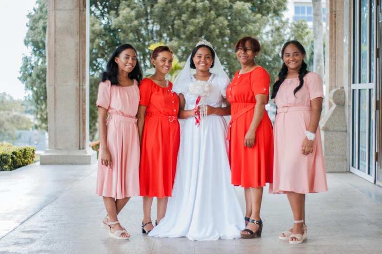 a bride with her bridals in peaches and pink