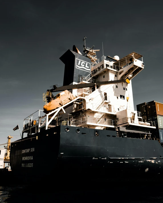 an enormous cargo ship at sea with stairs up to it