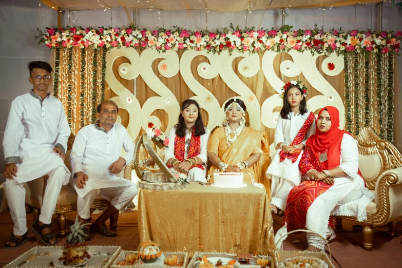 a group of people sitting around each other with food