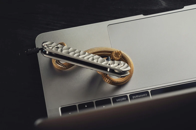 a small computer with a golden handle is shown