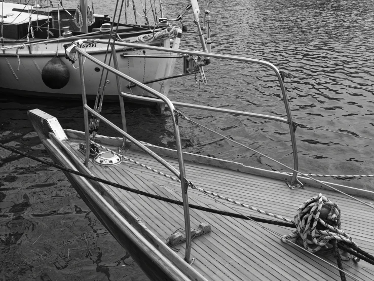 black and white po of docked boat and ladder