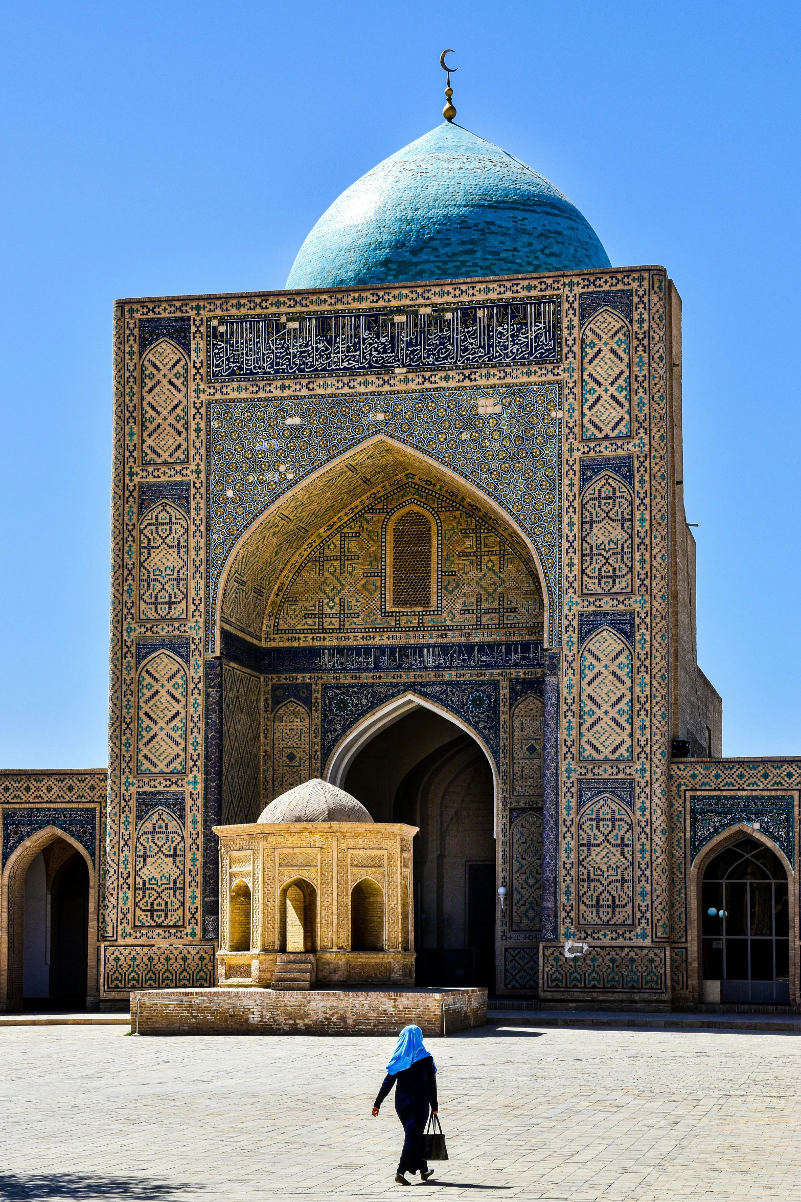 a woman standing in front of a stone building