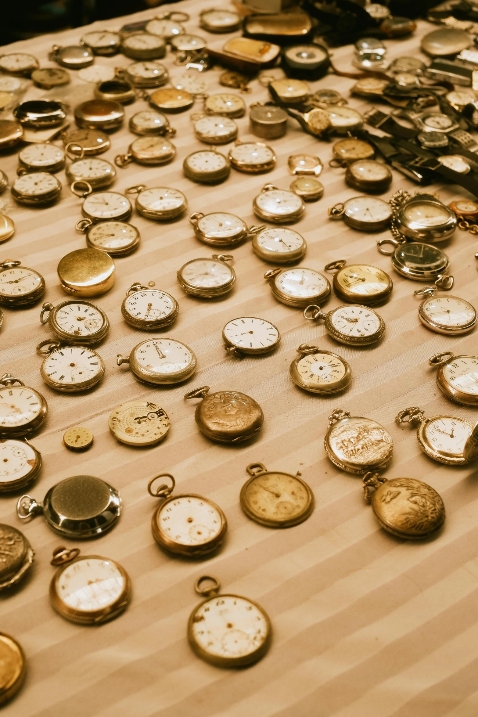 many old and rusty watches on a table