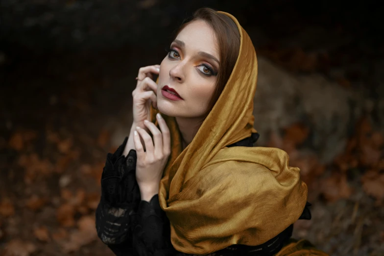 a woman in black dress sitting on a rock