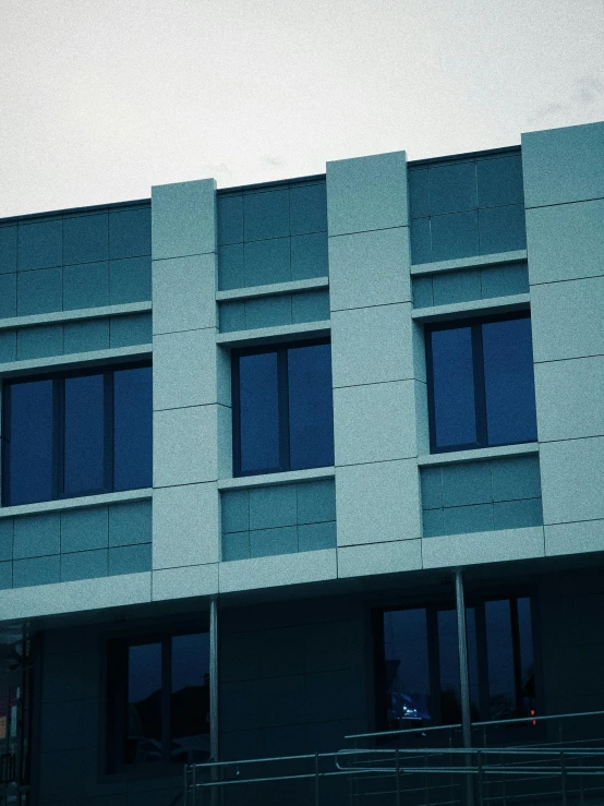 an airplane is flying near the windows of a building