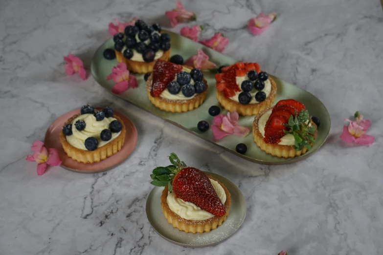 a plate with two dessert plates, three cakes and one pie