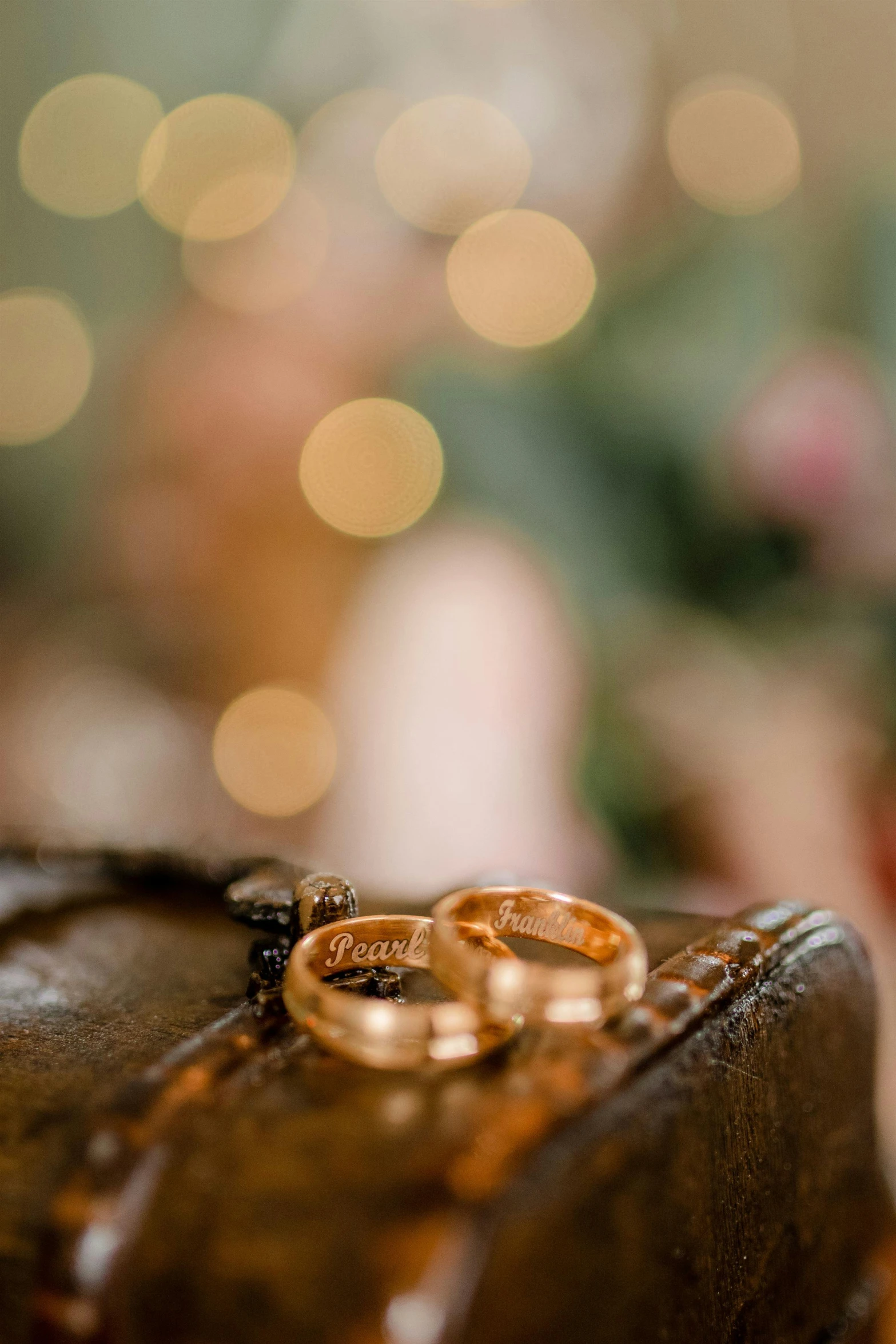 two golden rings sit on top of a brown case