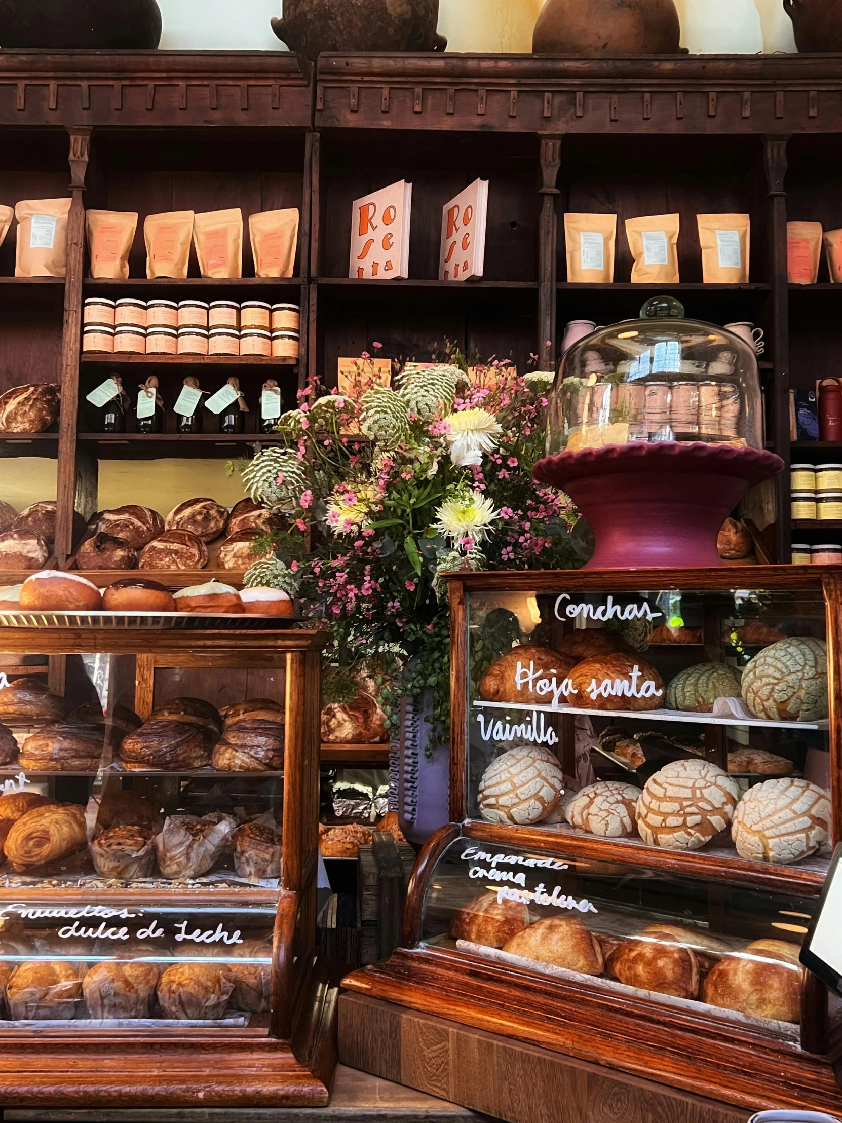 there are many cakes and pastries in the display case