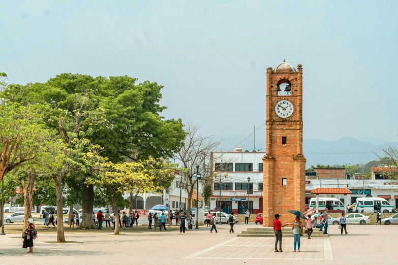 a tall clock tower in a small town square