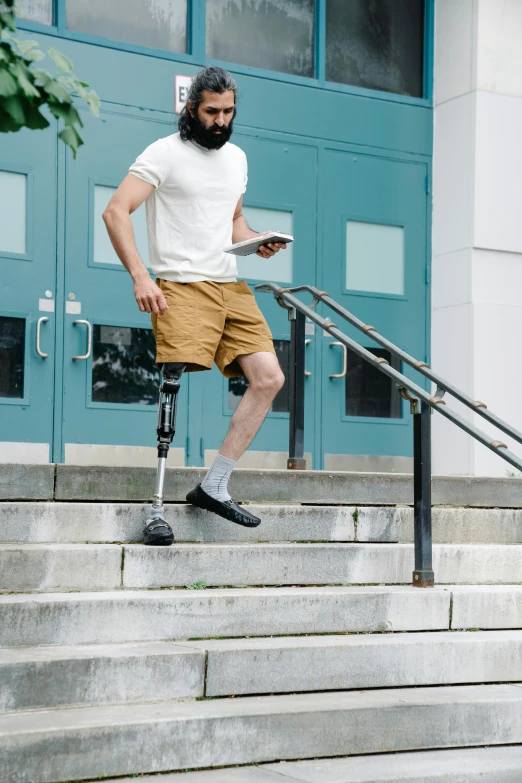 a man wearing an on cast is walking up stairs