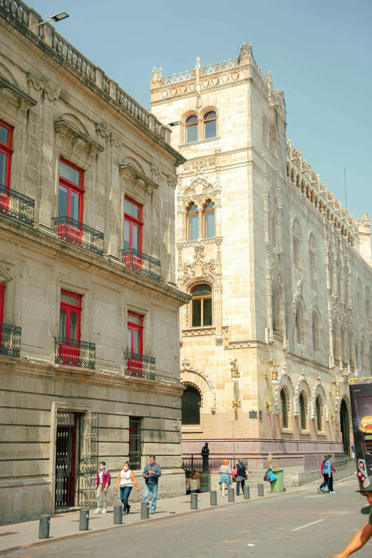 large historic building with a lot of people walking around