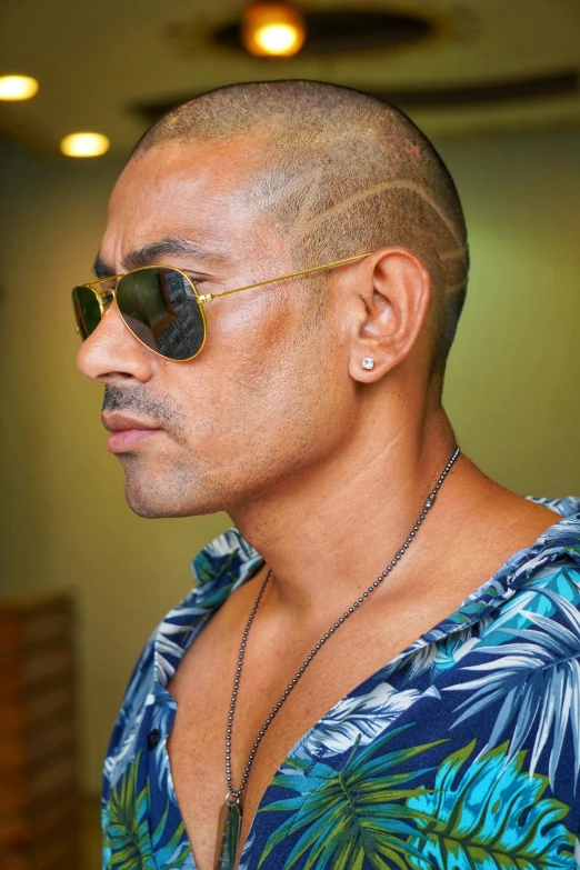 a man with a short shaved head wearing sunglasses