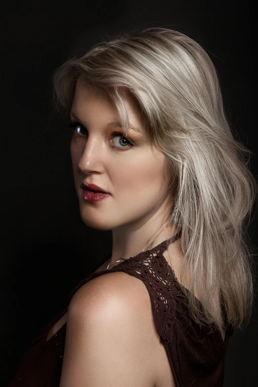 a blond woman in brown dress with a long silver bob