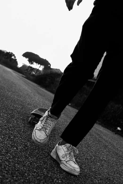 a person is walking and posing with sneakers on