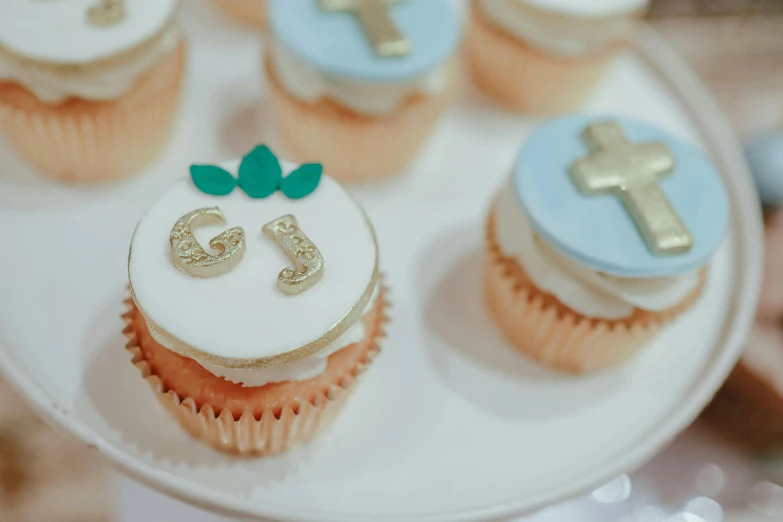 cupcakes and cake decorated with small fondant designs