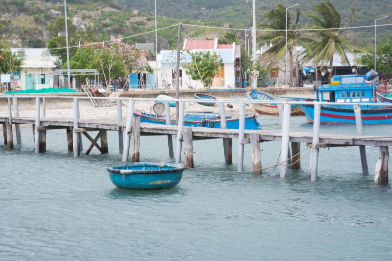 small boat parked on water near a pier