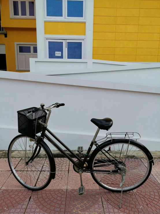 a bicycle is parked next to a building with windows