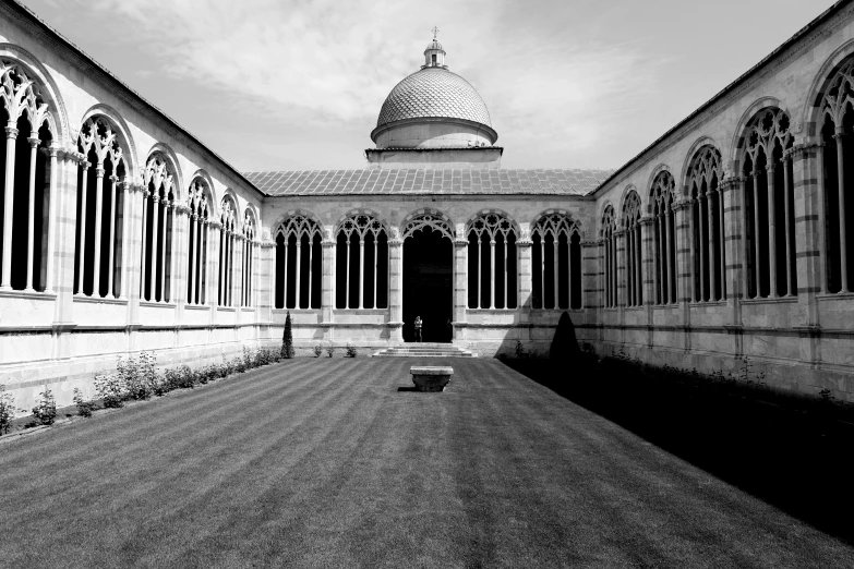 a building has a stone courtyard and large windows