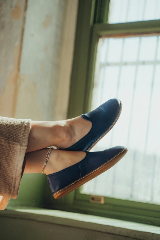 the feet of a woman in blue shoes are shown