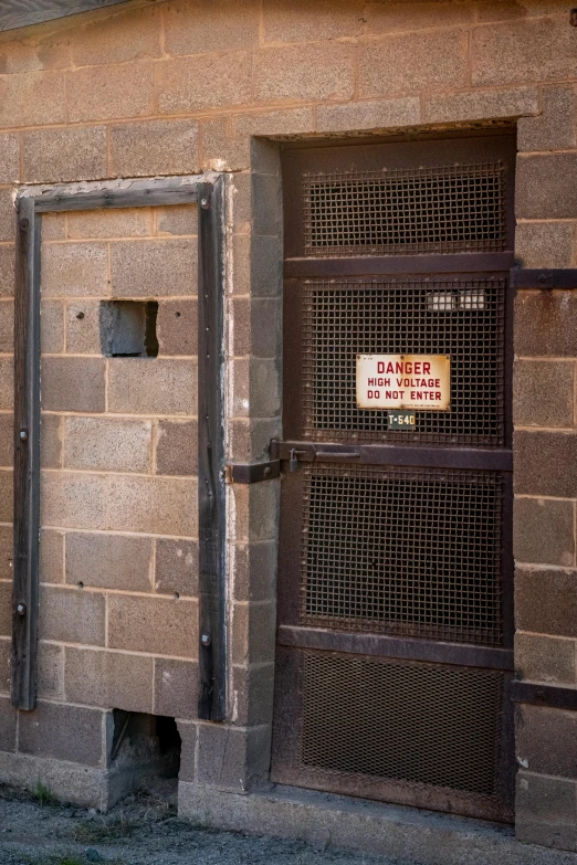 a brick building with a metal gate and a sign