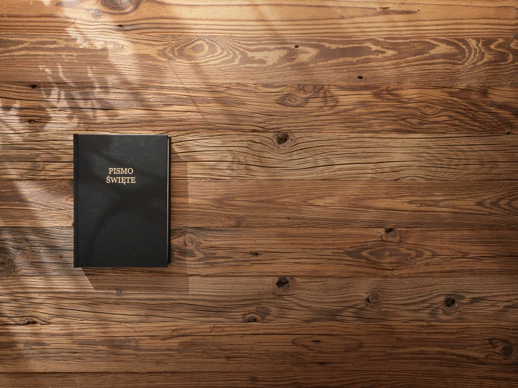 a bible that is on a wood floor