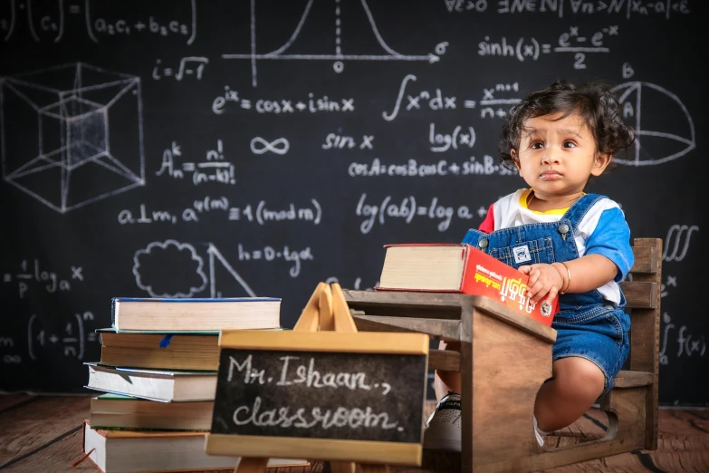 a young child with books and a board of school stuff