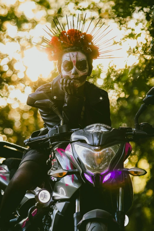 man in skeleton makeup sitting on his motorcycle