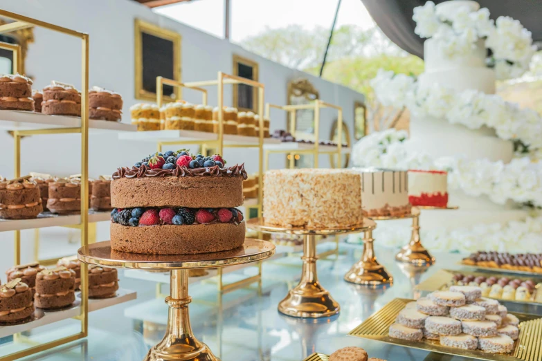 a variety of desserts sitting on display behind glass