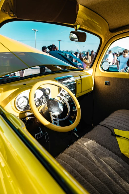 a very bright yellow car with some black leather seats