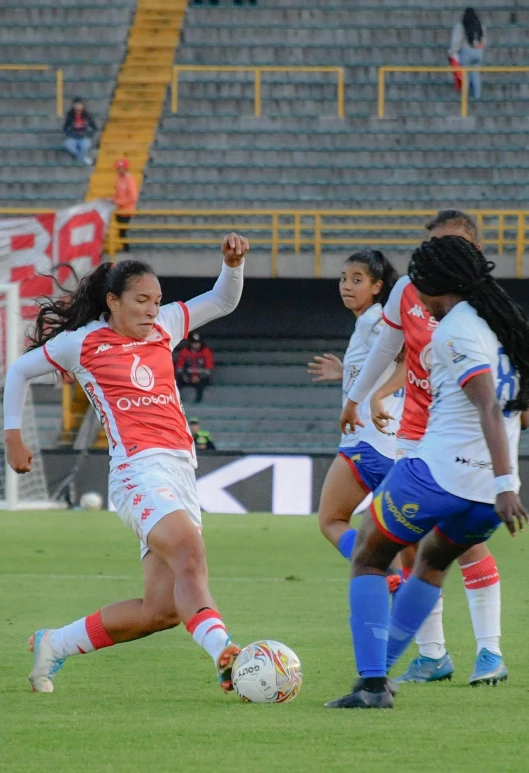 a group of girls that are playing a game of soccer