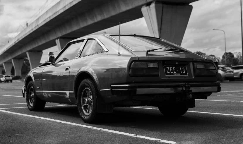 a classic car parked in the parking lot in a black and white po