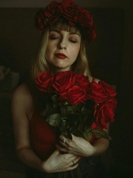 a beautiful woman holding roses in her hands