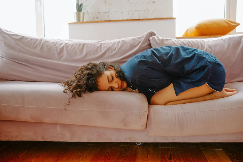 a person lays down on the couch