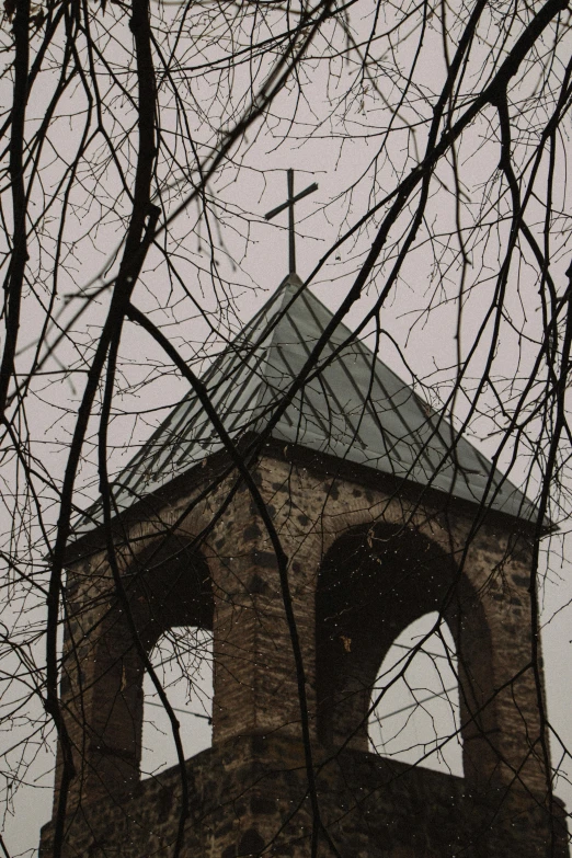 there is an old church bell tower with a cross on the top