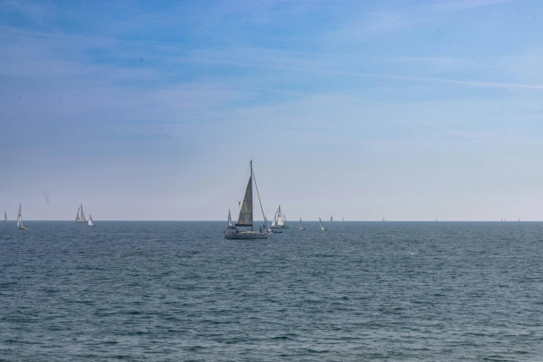 a large body of water with several small boats floating in it